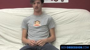 On a couch by himself cute gay man Danny jerks off his dick