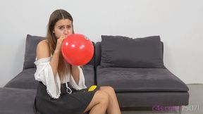 Cute Michelle is blowing up small party balloons (HD quality)