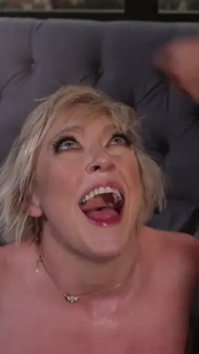 Dee Williams reclining with an open-mouthed expression of pleasure