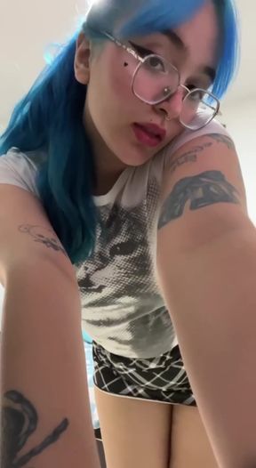 Blue-haired woman in a blue shirt taking a selfie