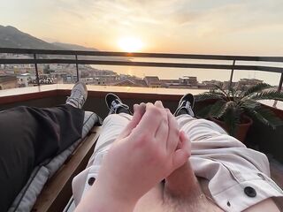 Horny handjob at sunset with a view over the bay