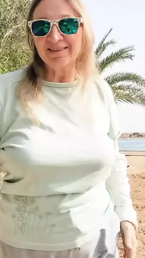 Busty GILF dances and strips, showing off big natural tits