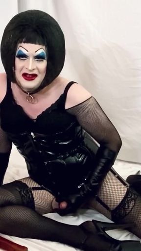 Captivating moment from "Sissy in PVC and Heavy Makeup Begs Master to Cum"