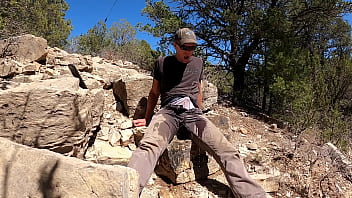Pissing grey pants in the mountains