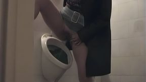 Street hooker takes a piss in a pub in the men&#039;s toilet