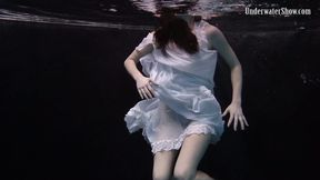 Graceful Andrejka strips her dress off underwater