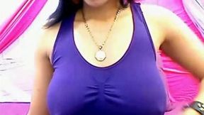 Huge-breasted ebony hottie licks her nipples in front of a webcam