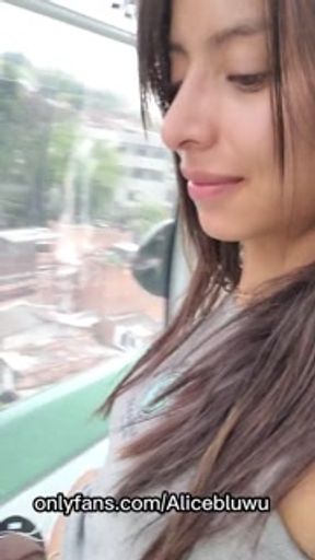 Sexy Latina brunette showing her tits in a nice city