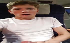 Handsome young dude masturbating on a plane