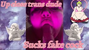 Up close trans dude sucks fake cock
