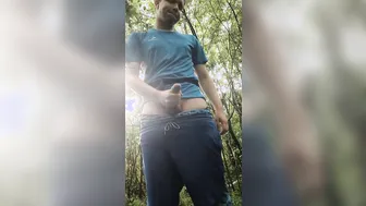 Twink jerks off his big uncut cock in the forest and cums hard