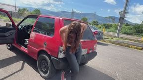 Annie tries to turn off the car from the muffler while wearing Converse.