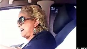 Bosomy blonde granny gives me a good handjob in a car