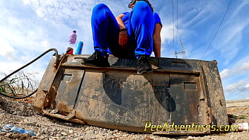 Chubby brunette pee on this excavator bucket