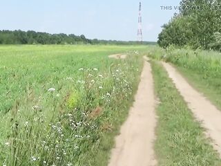 Gorgeous stripped walk in the wild: Naturist posing in a green spring field