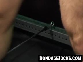 Bigg Pete struggles against chains tied down to his balls