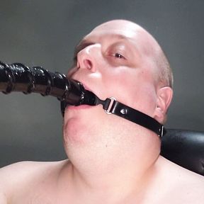 Deepthroating an 18 inch dildo with mouth gag ring