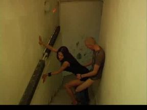 Hot brunette in black dress and high heels sneaks out on a staircase with her lover, fucks him standing and then sucks his cock dry