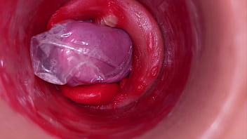 The camera inside the deep pussy records a huge ejaculation with a stuck condom