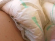 Dirty piss-filled diaper shown in a public garden under a white skirt