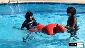 TANGENTOD Women in Black Catsuits Float Red Latex Encased Figure on Inflatable R
