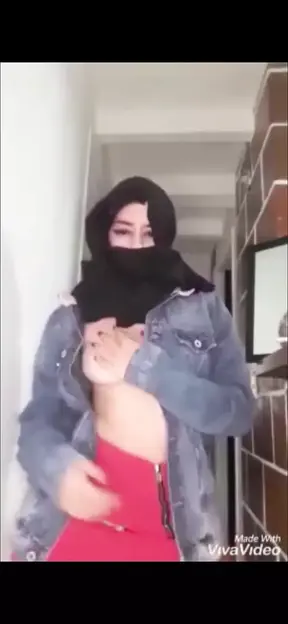 Arab wearing burqa and kneeling for her master