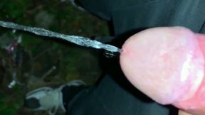 Slowmotion and Close up. Unwashed Uncut Cock Piss on the Ground Outdoor. Long Piss Stream