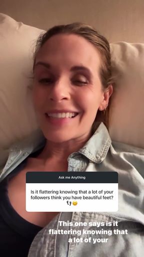 Smiling woman in bed with caption