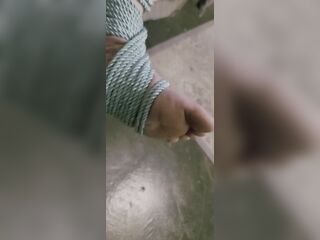 Transgender foot with painted toes in a shibari sandal