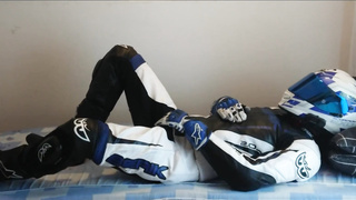 Queer biker draining off in Berik leather suit, Alpinestars shoes and mittens, Scorpion helmet