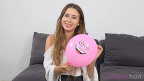 Cute Michelle is blowing up small party balloons (4K quality)