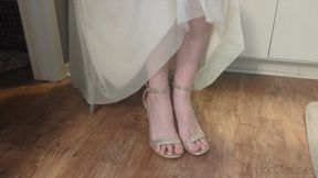 Fifi playing in sparkly nude heels trying to scrunch her toes to free them from the toe strap