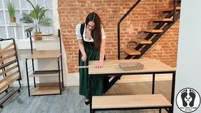 sensual latina carpenter cutting wood in a dirndl