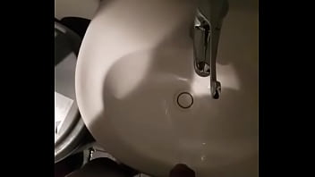 Man pissing in sink in restuarant