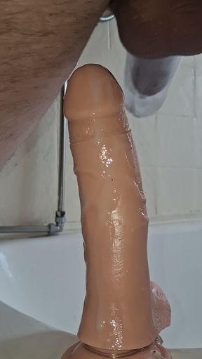 Sissy gets dildo in the ass in bathroom