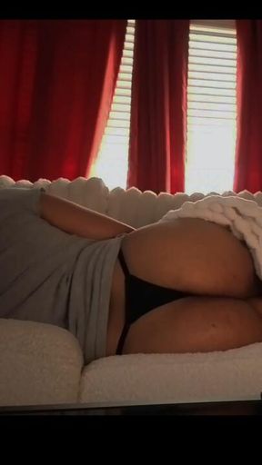 Wife relaxing on the couch in a thong