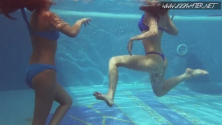 Two hot lesbian brunettes in the swimming pool