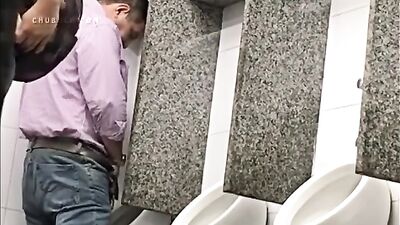 Kinky guys are filmed jerking off in the public urinal