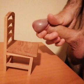 Handjob and cumshot on a small wooden chair