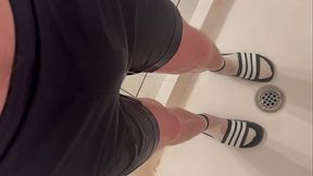 Amateur boy in white socks and adidas slides wetting his blue shorts - POV (filmed by himself)
