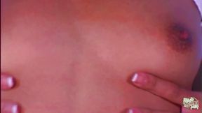 An Asian woman engages in sexual activity with a black man, bouncing her buttocks on his erect penis