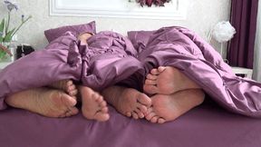 BAREFEET UNDER A BLANKET (sp)