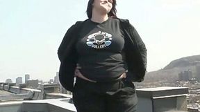 Young BBW babe strips on the roof and fondles her shaved coochie