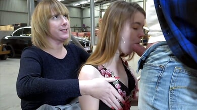 Strict femdom session unfolds in a public warehouse with bondage and deepthroat