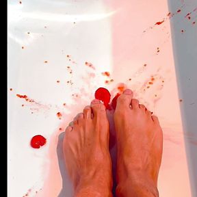 Perfect sexy brown feet squish tomatoes in bathtub