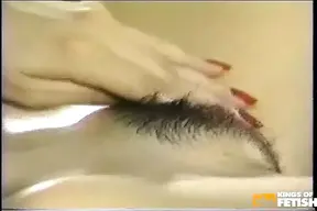 Thai babe plays with her wet, hairy pussy