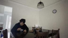 Unhappy Asian teenager cries while eating cereal alone in the dark,