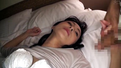 Black-haired Asian woman performs oral sex on her partner in bed