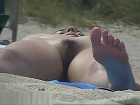 Busty girl shows her mighty jugs on a nudist beach