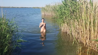 The girl goes completely naked out of the river